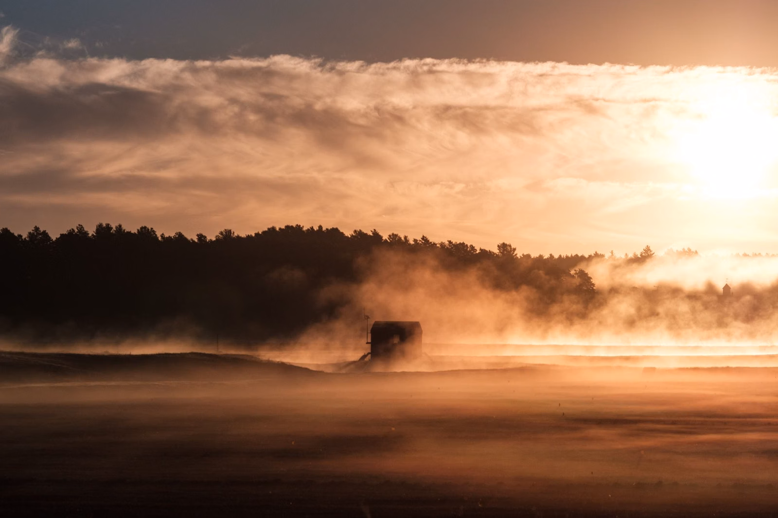 Mist rising off a pond at sunrise in Carver, Massachusetts